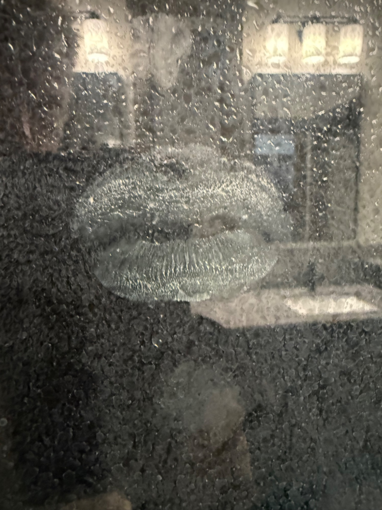 Inspiration for Charles Randolph's poem "A Place Reserved for her" – To Speak Online Kiss impression on fogged shower door glass