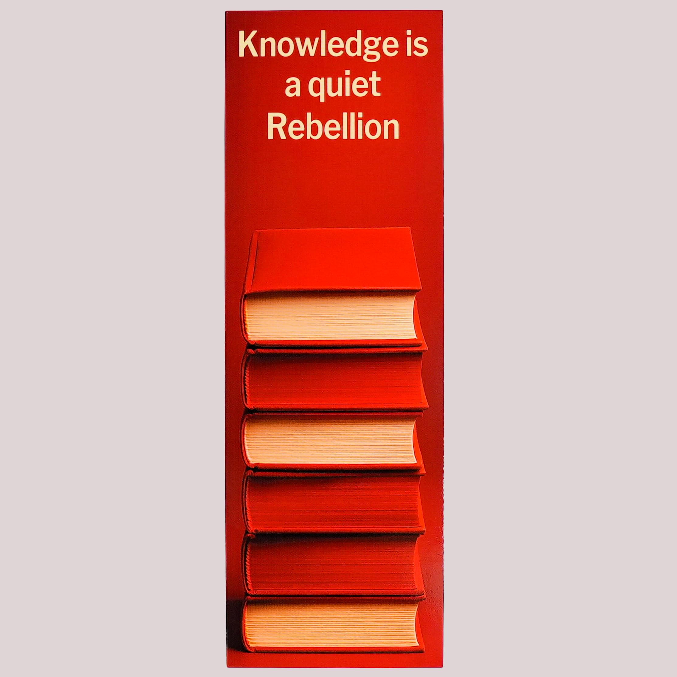 Version 100 – To Speak Online Red panel above a stack of red books with the white text: 'Knowledge is a quiet Rebellion'.
