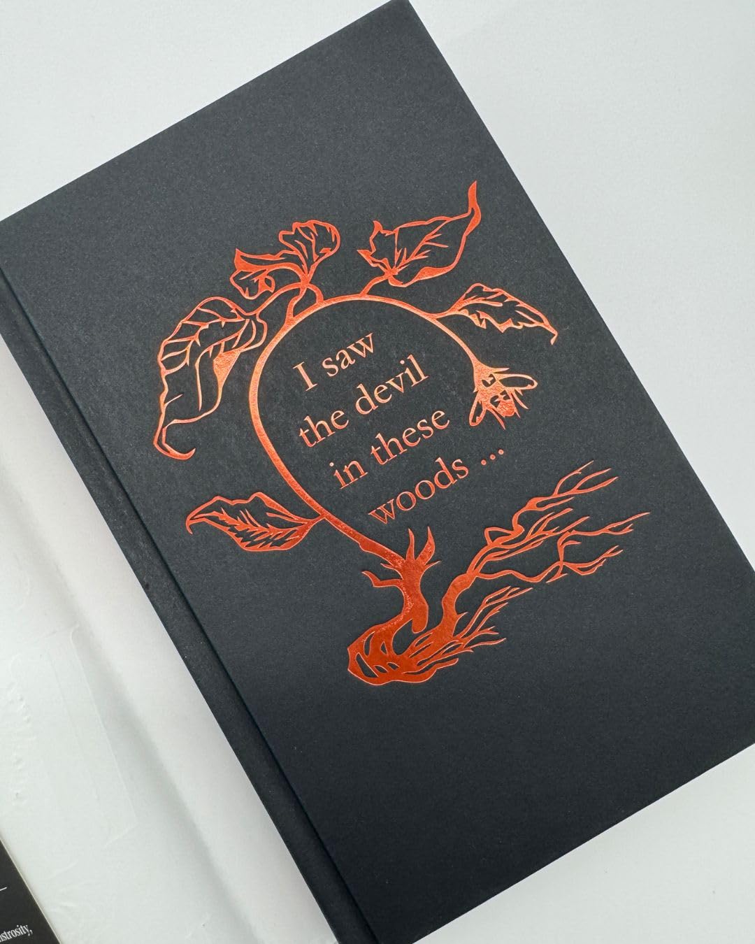 Version 100 – To Speak Online Dark book cover featuring copper-foil vines around a circle with the text 'I saw the devil in these woods...'