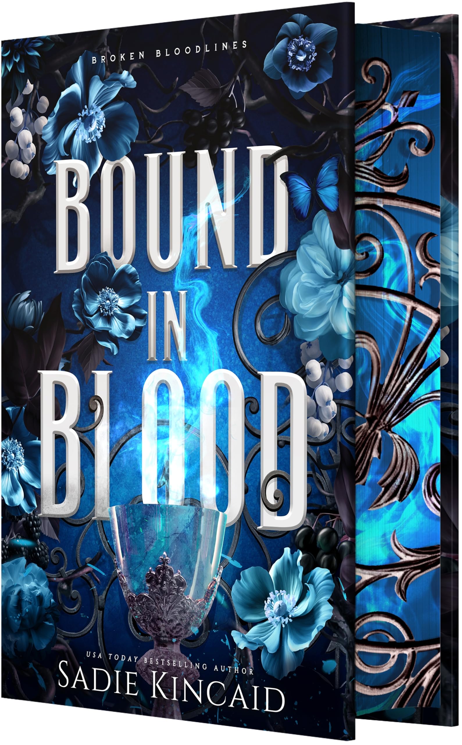Version 100 – To Speak Online Book cover for 'Bound in Blood' by Sadie Kincaid, featuring blue flowers, a frosted glass cup, and ornate swirls against a dark blue background