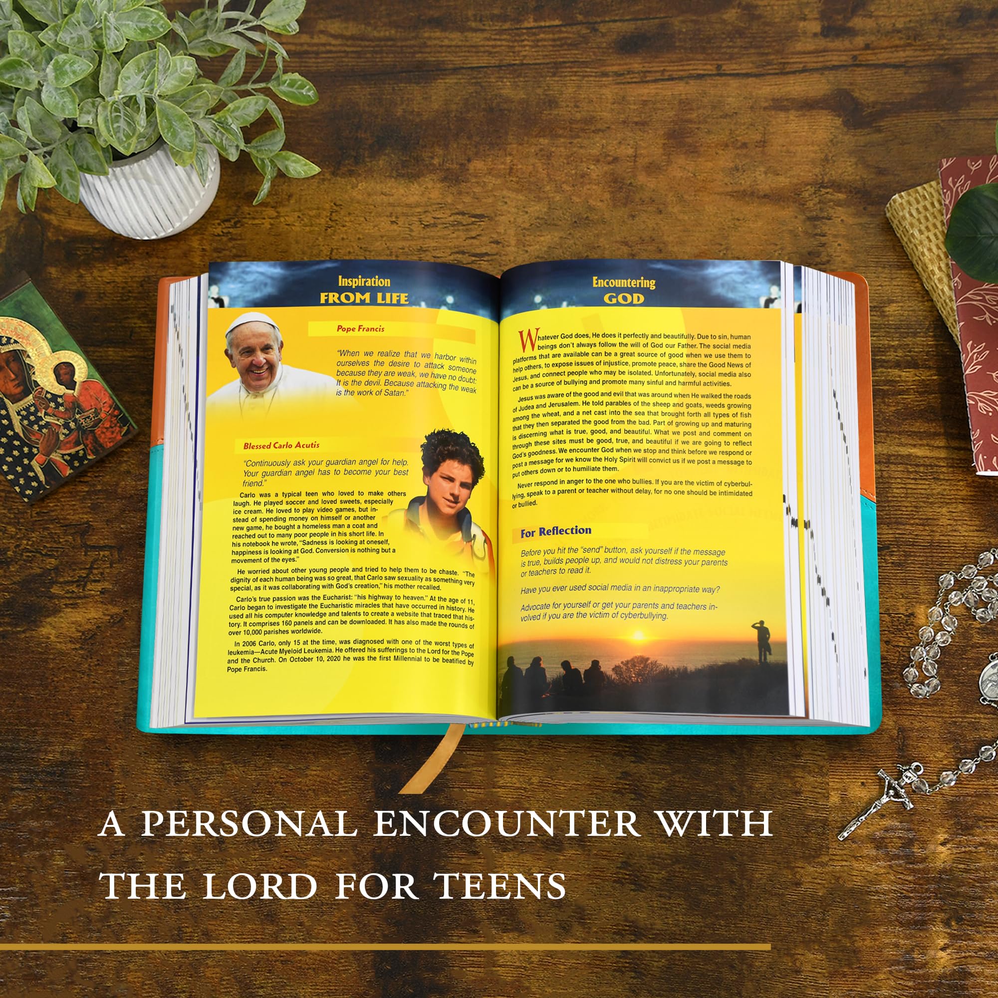 Version 100 – To Speak Online Open magazine on a wooden table with bright yellow pages about faith, a potted plant on the left, and a cross necklace on the right edge.